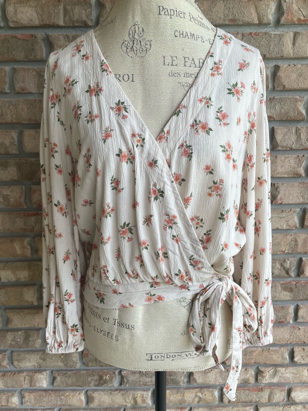 American Eagle Outfitters Cream Faux Wrap Boho Top with Pink Floral Print.
